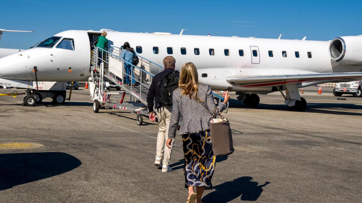 Tara Capalbo, front, of Laguna Niguel boards her JSX flight with other passengers at John Wayne Airport in Costa Mesa on Thursday, April 23, 2026. (Photo by Leonard Ortiz, Orange County Register/SCNG)