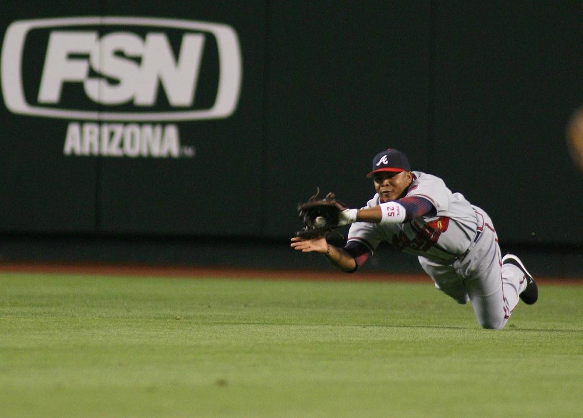  Atlanta Braves center fielder Andruw Jones makes the diving catch at Chase Field. Rick Scuteri-US Presswire via Imagn Images