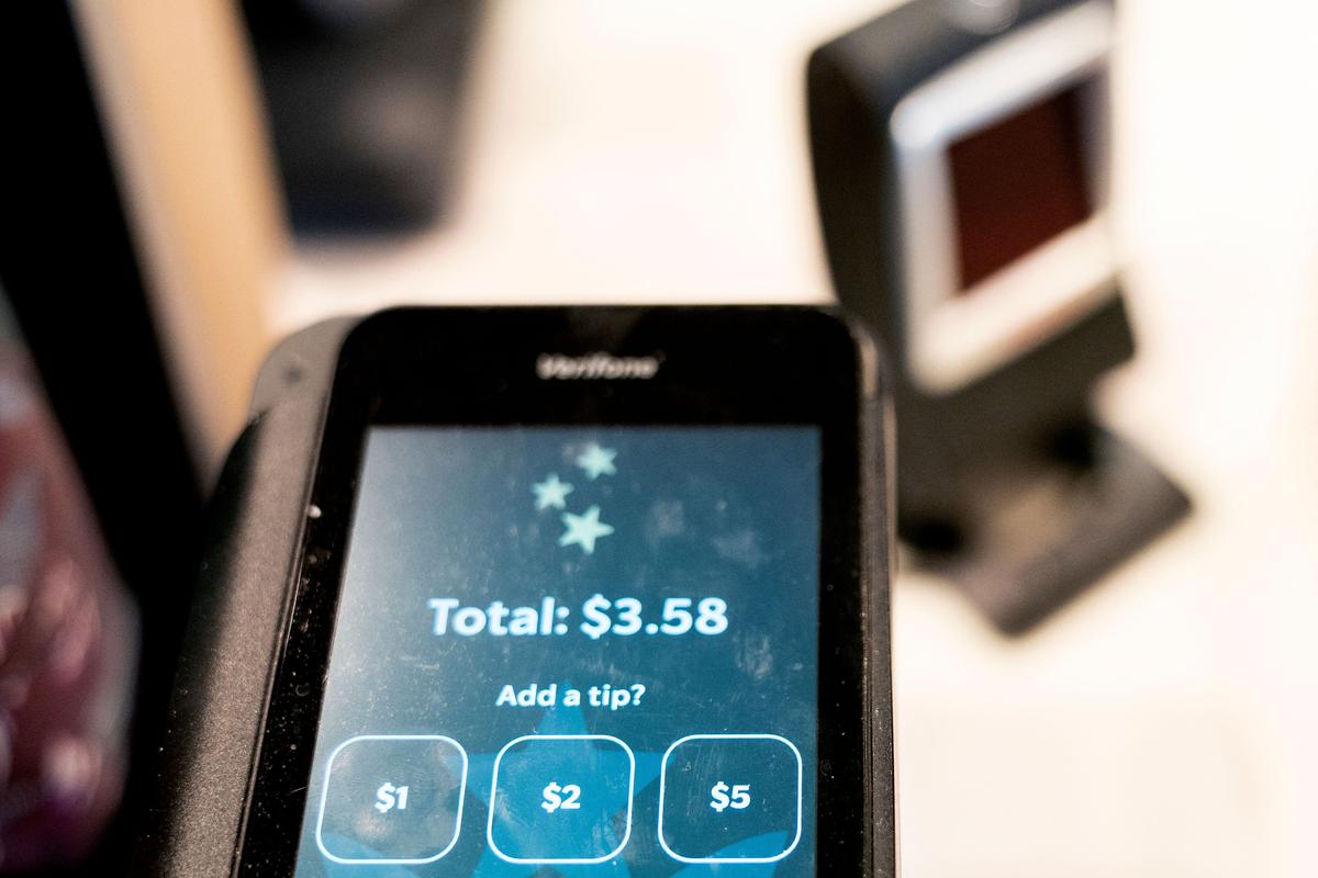  Tip options are displayed on a credit card reader at a store in Washington, D.C., on March 17, 2023. (Photo by STEFANI REYNOLDS/AFP via Getty Images) 