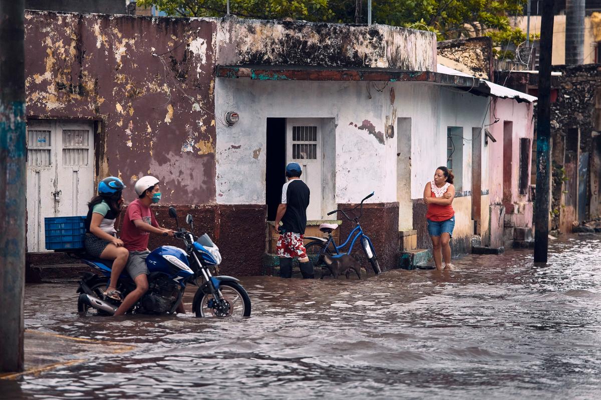 A couple rides a motorcycle along a flooded street after the passing of Hurricane Delta in Tizimin, Mexico, Wednesday, Oct. 7, 2020. Remnants of the storm could deliver heavy rain and tornadoes to North Carolina over the weekend, a National Weather Service forecaster said.