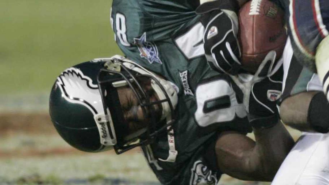  Feb 06, 2005; Jacksonville, FL, USA; Philadelphia Eagles receiver Freddie Mitchell (84) is hit by New England Patriots linebacker Tedy Bruschi (54) and Roman Phifer (95) during Super Bowl XXXIX at Alltel Stadium. The Patriots won the game 24-21. Mandatory Credit: Imagn Images | Imagn Images 