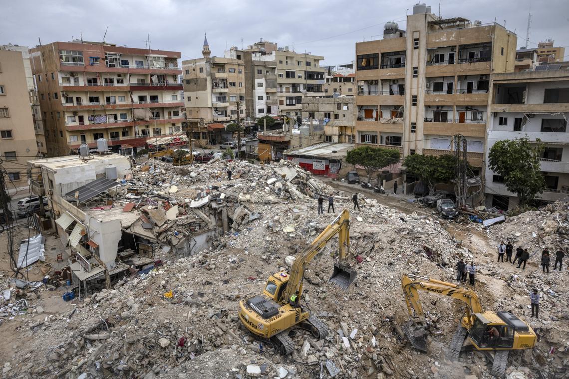 Rescue workers search for victims buried in the rubble of several buildings destroyed by an Israeli airstrike in Tyre, Lebanon, on Sunday, April 19, 2026. (David Guttenfelder/The New York Times)