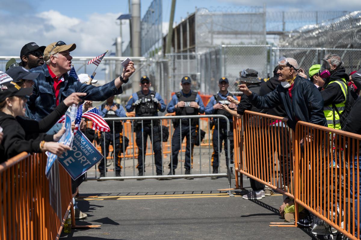 Anti-ICE demonstrators and counterprotested yell at one other outside Delaney Hall, a federal detention facility in Newark, N.J. on Saturday, May 30, 2026. Clashes between protesters and armed federal agents here have flared off and on since the Memorial Day weekend; on Friday, federal officials left the area outside the detention center so that the state police could assume control. (Vincent Alban/The New York Times)
