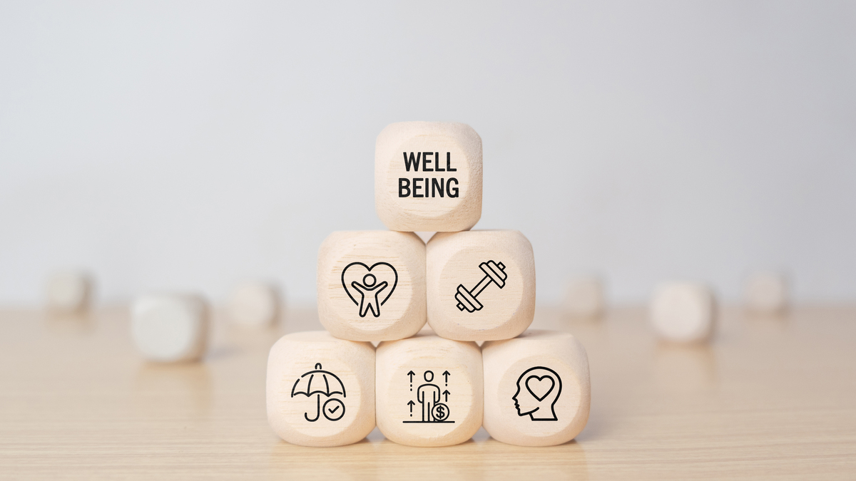 Wooden blocks with physical, mental, emotional health icons.