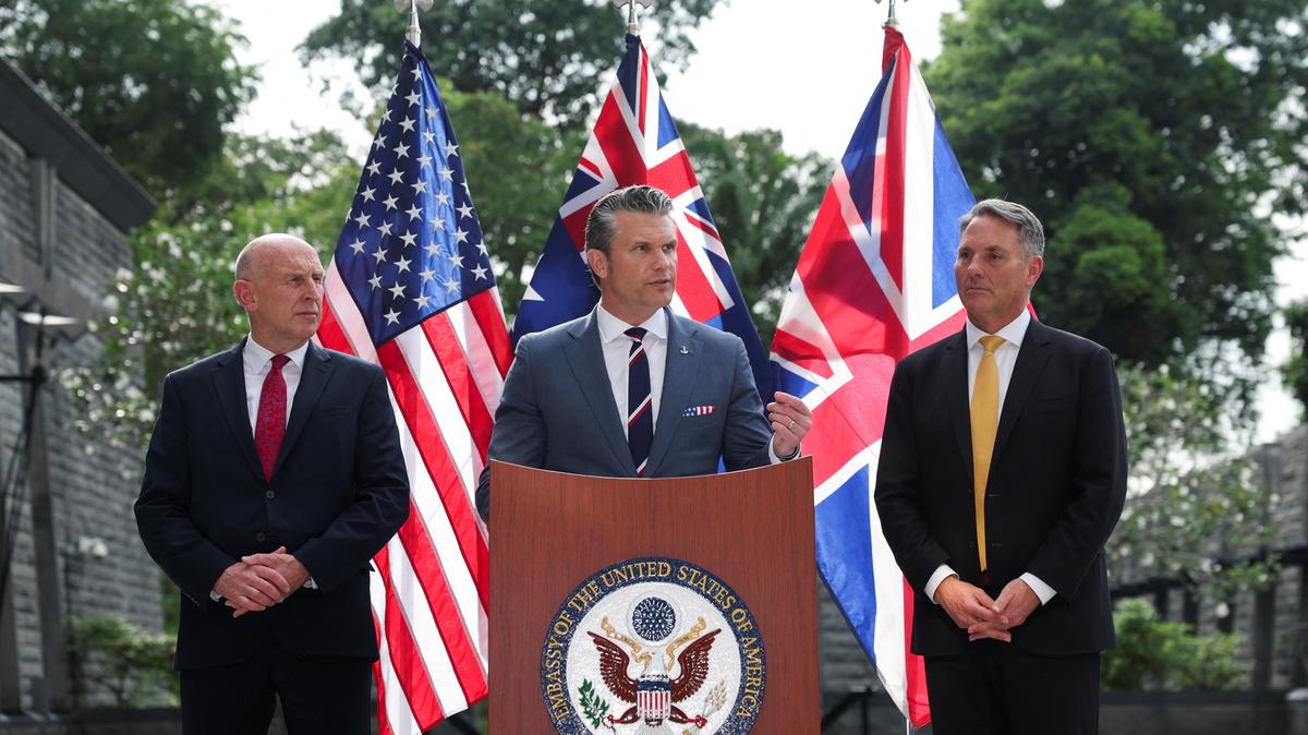 Australian Defense Minister Richard Marles and British Defense Secretary John Healey look on as U.S. Secretary of Defense Pete Hegseth speaks during an AUKUS Defense ministers' press conference at the U.S. Embassy in Singapore, May 30, 2026.
