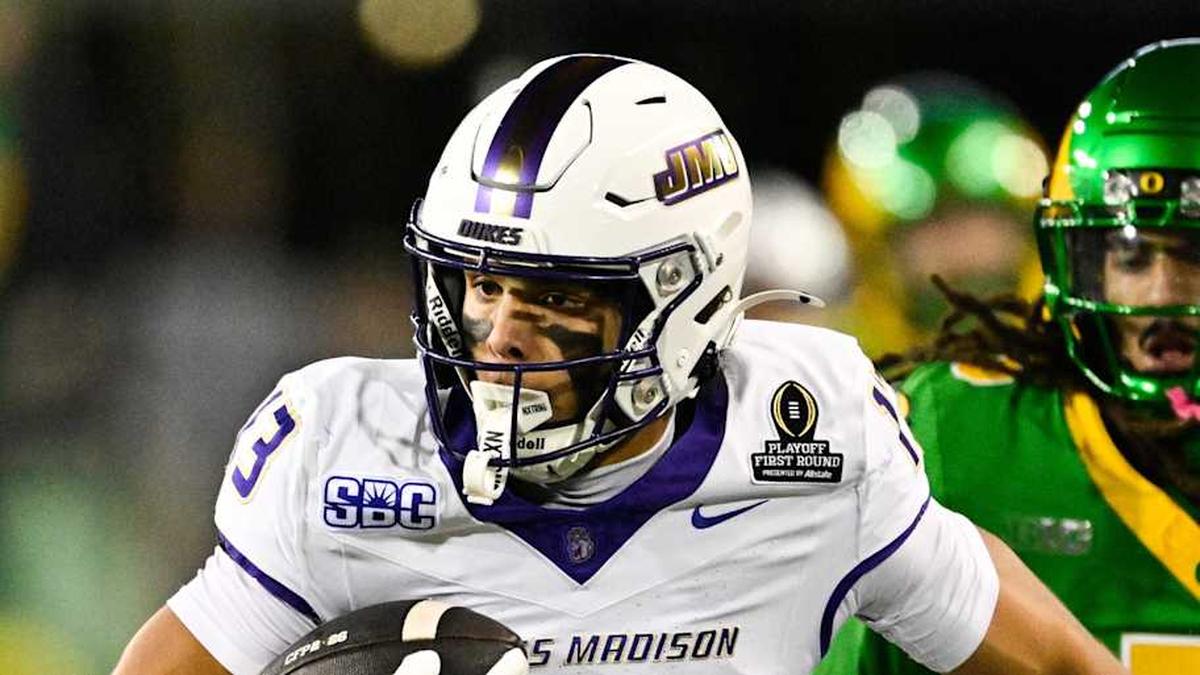  Dec 20, 2025; Eugene, OR, USA; James Madison Dukes wide receiver Landon Ellis (13) runs after making a catch as Oregon Ducks defensive back Theran Johnson (5) defends during the second quarter at Autzen Stadium. Mandatory Credit: Troy Wayrynen-Imagn Images | Troy Wayrynen-Imagn Images 