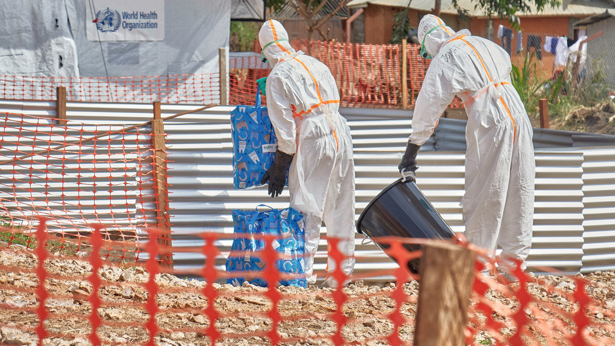 Congolese medical workers dressed in personal protective equipment (PPE) handle bags at the Centre Medical Evangelique (CME) within the secured Ebola response zone, as aid agencies intensify efforts to contain the Ebola outbreak involving the Bundibugyo strain, in Hoho commune of Bunia town, Ituri province, Democratic Republic of Congo, June 9, 2026. REUTERS/Gradel Muyisa Mumbere