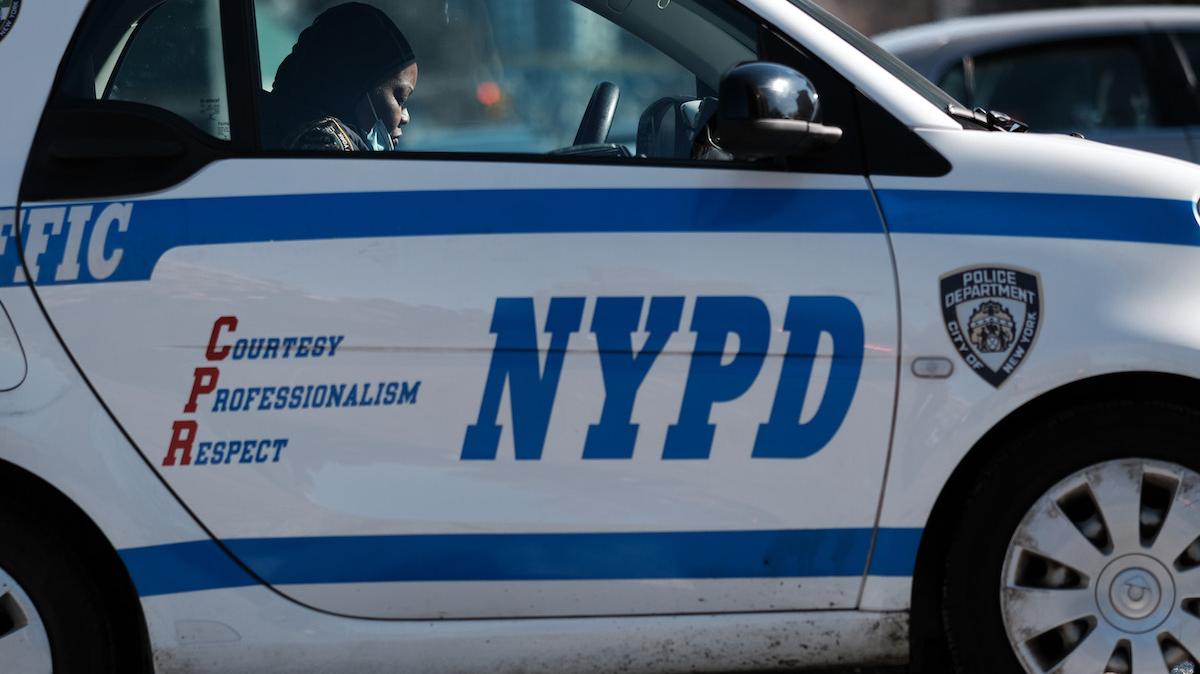 NEW YORK, NEW YORK - JANUARY 22: A police officer sits in her car in Harlem where two New York City police officers were shot last night after responding to a domestic call on January 22, 2022 in New York City. One of the officers, Jason Rivera, was killed while a second officer is in critical condition. The incident follows a series of high profile shootings in New York City over the past few weeks.  (Photo by Spencer Platt/Getty Images)