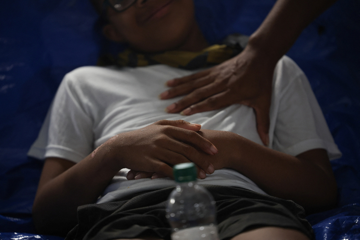 A person rests, at a field hospital, which is part of the U.S. State Department's coordination, in the aftermath of the June 24 earthquakes, in La Guaira, Venezuela, July 4, 2026. REUTERS/Adriano Machado