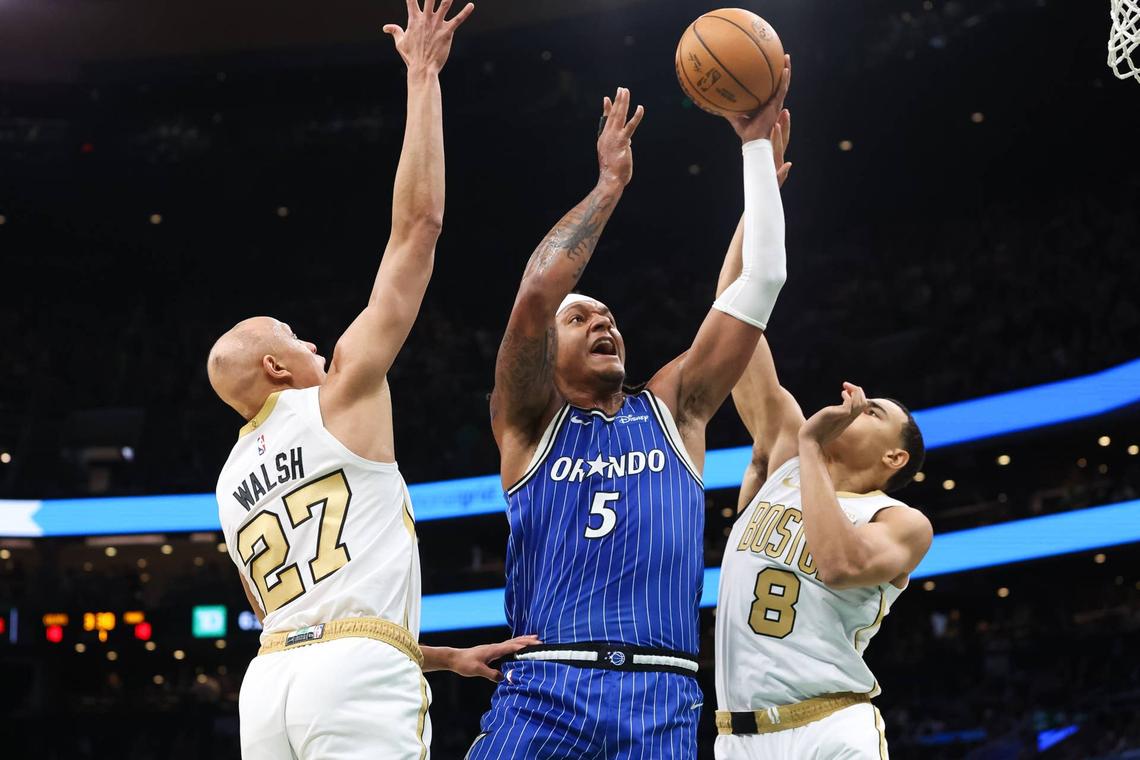  Orlando Magic forward Paolo Banchero shoots defended by Boston Celtics guard John Tonje Paul Rutherford-Imagn Images