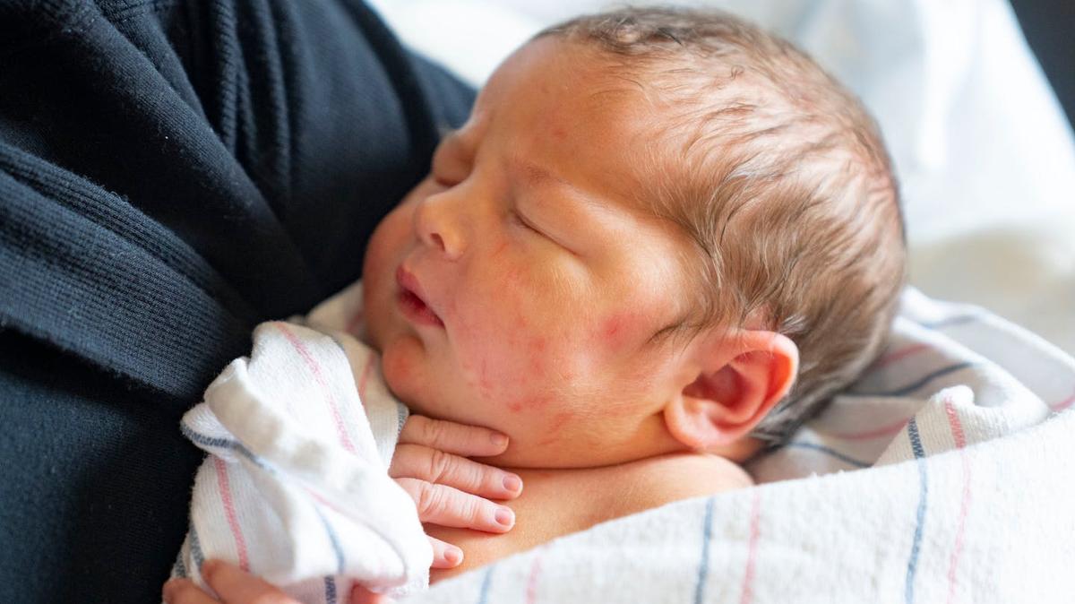 A newborn baby girl is held by her mother at Maple Grove Hospital in 2022. (Alex Kormann/The Minnesota Star Tribune/TNS)