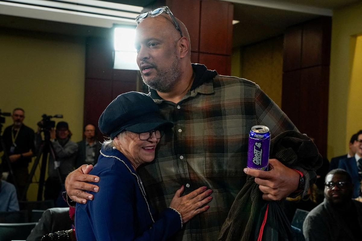 FILE PHOTO: Former U.S. Capitol Police officer Harry Dunn embraces Pamela Hemphill, who pleaded guilty to a misdemeanor for entering the Capitol on January 6, 2021, and rejected her pardon from U.S. President Donald Trump, before the start of a Capitol Hill forum to mark the fifth anniversary of the January 6, 2021, attack on the U.S. Capitol in Washington, D.C., U.S., January 6, 2026. REUTERS/Elizabeth Frantz/File Photo