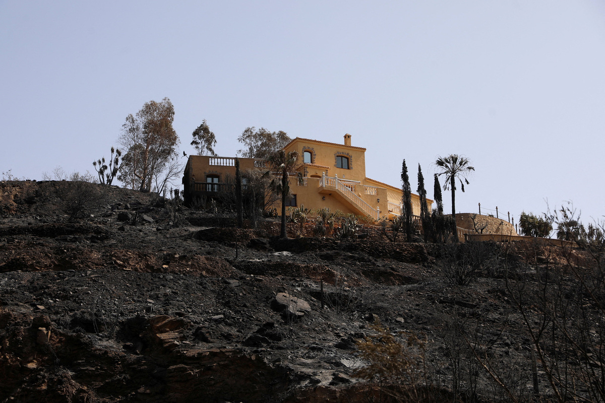 A damaged house remains amidst a burned area following deadly wildfires affecting Almeria province, in Bedar, Almeria, Spain, July 11, 2026. REUTERS/Loyola Perez de Villegas Muniz