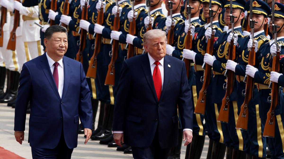 U.S. President Donald Trump reviews an honor guard with Chinese President Xi Jinping during a welcome ceremony at the Great Hall of the People on May 14, 2026, in Beijing, China. President Trump is meeting with President Xi Jinping in Beijing to address the Iran conflict, trade imbalances, and the Taiwan situation while establishing new bilateral boards for economic and AI oversight. (Alex Wong/Getty Images/TNS)