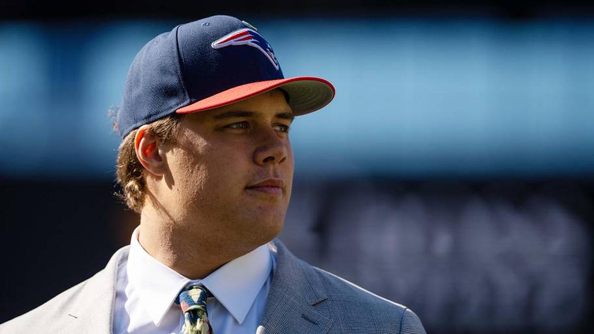  May 7, 2026; Foxborough, MA, USA; New England Patriots first round draft pick Caleb Lomu walks to the podium during a press conference on the game field at Gillette Stadium. Mandatory Credit: Natalie Reid-Imagn Images | Natalie Reid-Imagn Images 
