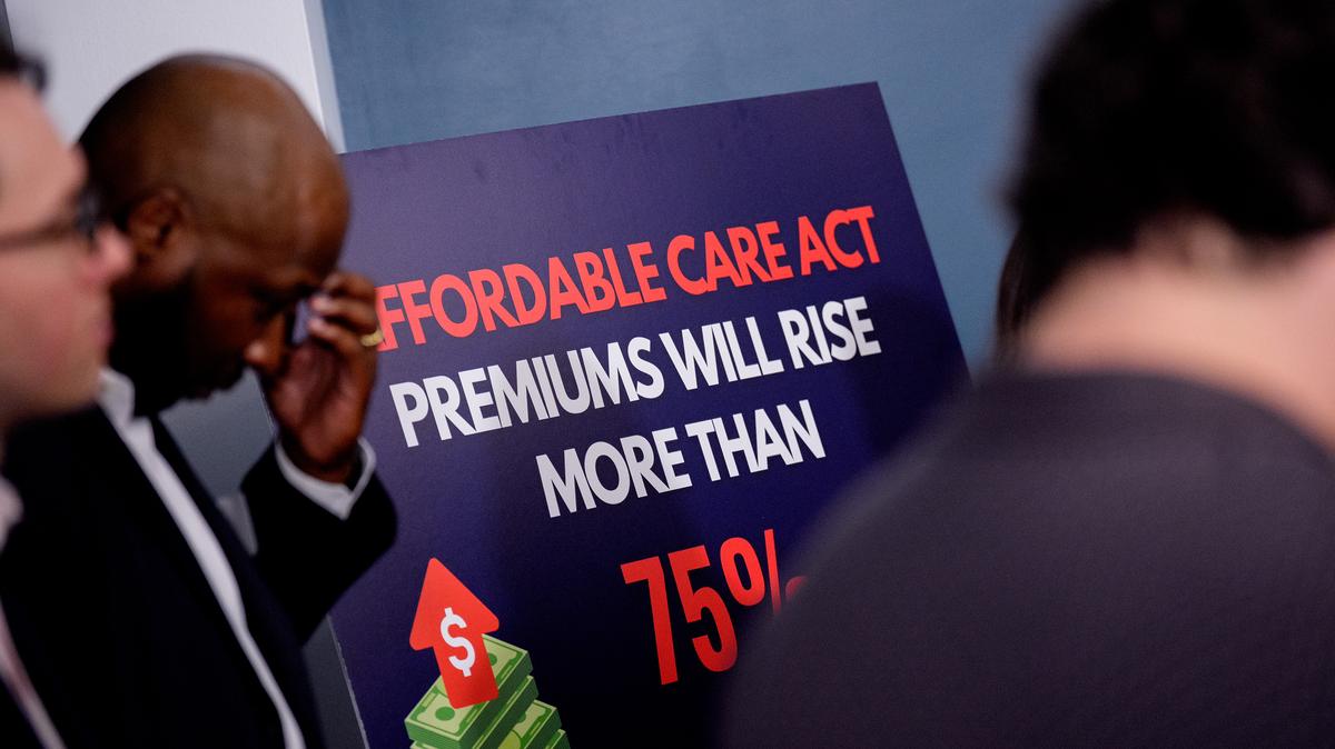 Lester Johnson, left, a restaurant owner in Richmond, Virginia, stands next to a sign that reads "Affordable Care Act Premiums Will Rise More Than 75 %" during a news conference to call on Republicans to pass Affordable Care Act tax breaks on Capitol Hill on Sept. 16, 2025, in Washington, D.C. (Andrew Harnik/Getty Images/TNS)