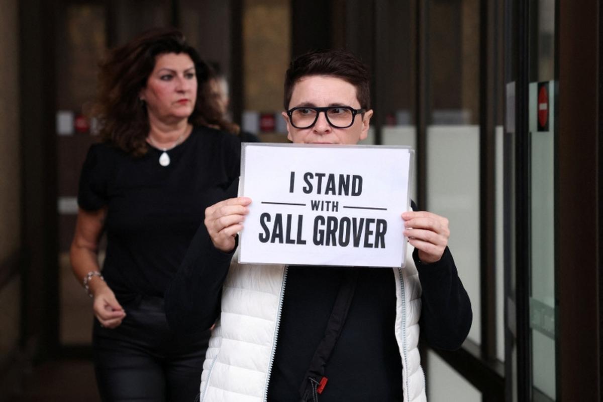 A supporter of Sall Grover, founder of female-only social networking platform Giggle for Girls, holds a sign after the Federal Court upheld a ruling that the exclusion of transgender woman Roxanne Tickle from the app was discriminatory, in Sydney, Australia, May 15, 2026. REUTERS/Hollie Adams