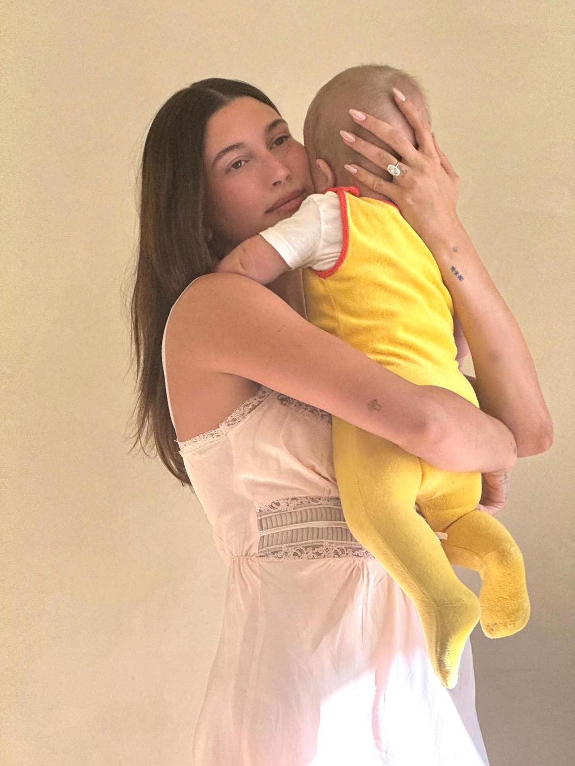 Mommy and Me Hailey cuddled her son close as he wore a yellow onesie and a white T-shirt for his Easter 2025 outfit. Courtesy of Hailey Bieber/Instagram