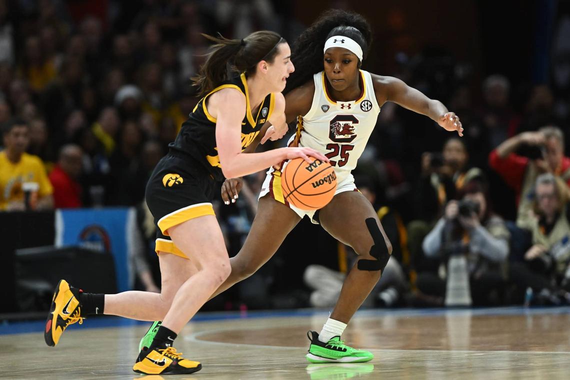 Iowa Hawkeyes guard Caitlin Clark (22) dribbles the ball against South Carolina Gamecocks guard Raven Johnson (25) in the Final Four. Ken Blaze-USA TODAY Sports