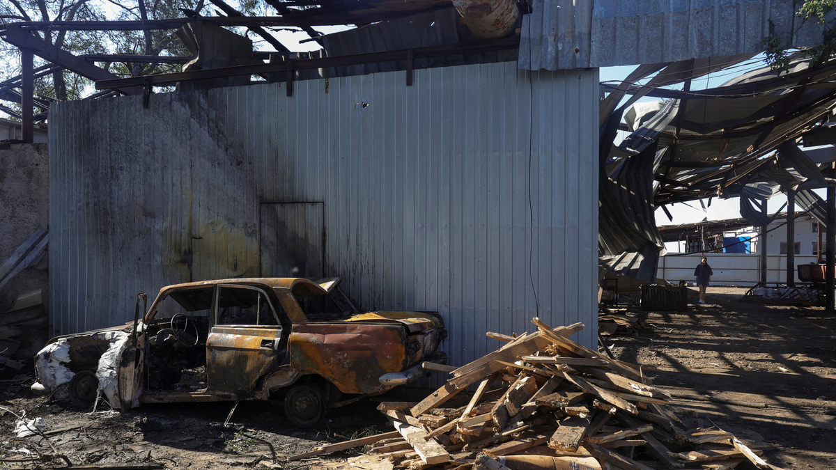 A woman walks at a compound of an agricultural enterprise hit by a Russian missile strike on Sunday evening, amid Russia's attack on Ukraine, in Odesa region, Ukraine June 22, 2026. REUTERS/Nina Liashonok