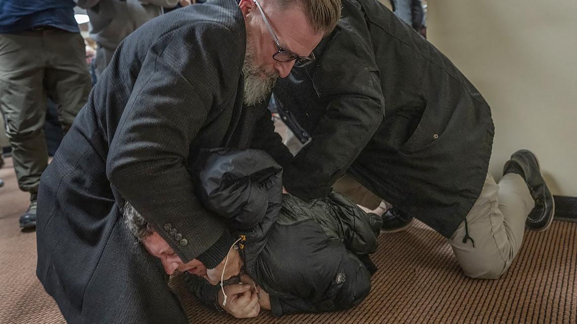 A man is tackled to the ground after spraying an unknown substance on U.S. Rep. Ilhan Omar during a town hall Jan. 27, 2026, in Minneapolis. (Richard Tsong-Taatarii/The Minnesota Star Tribune/TNS)