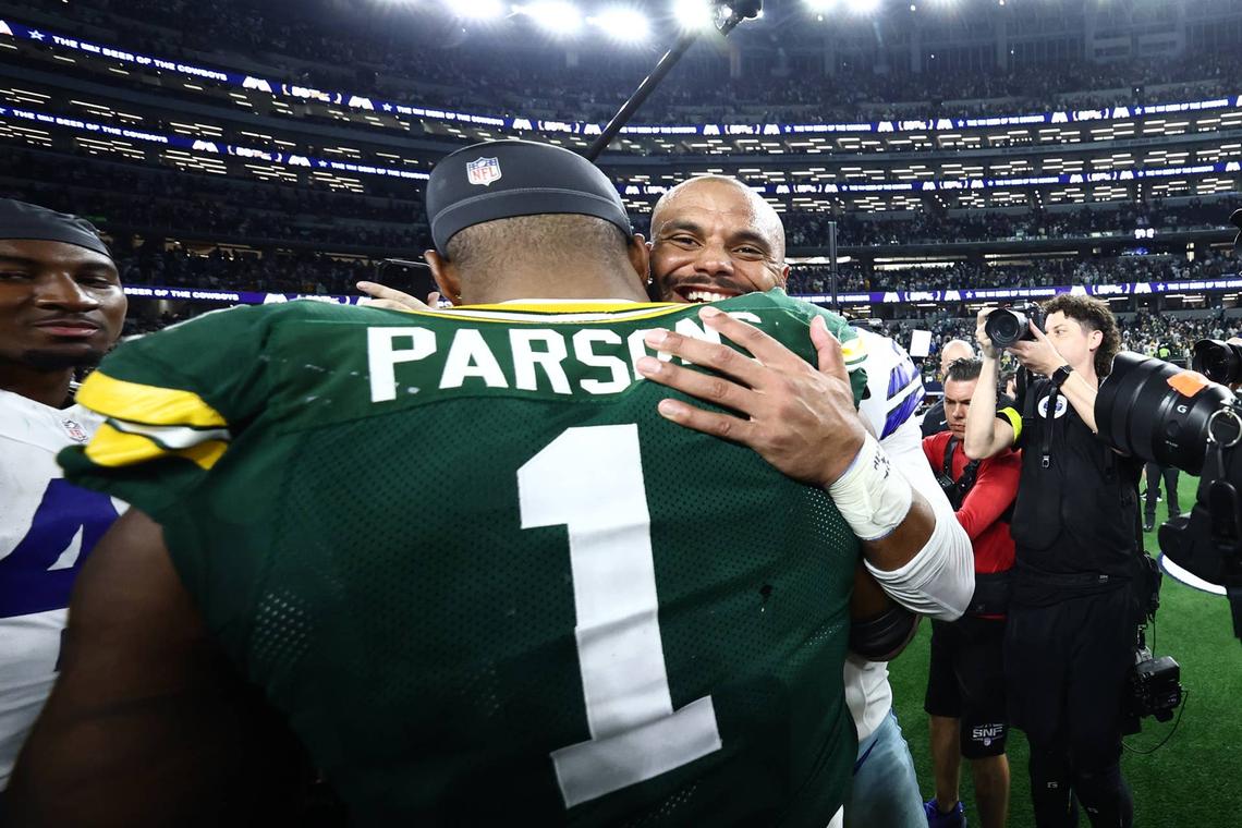  Sep 28, 2025; Arlington, Texas, USA; Green Bay Packers defensive end Micah Parsons (1) and Dallas Cowboys quarterback Dak Prescott (4) embrace after the tie game at AT&T Stadium. Mandatory Credit: Kevin Jairaj-Imagn Images 
