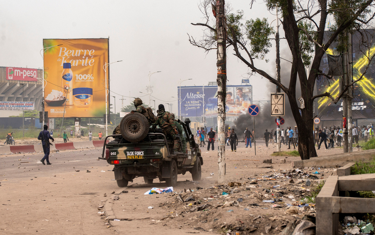 Security forces travelling in a vehicle disperse a crowd of protesters near the parliament building in Kinshasa, Democratic Republic of Congo, June 12, 2026.    REUTERS/Aristote Lokinda
