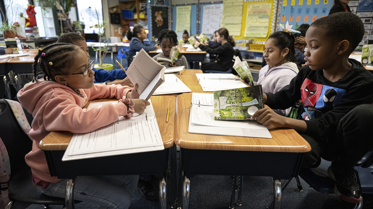 Fourth grade students, Cheyenne Wise, left, and Josiah Forney, read a book on Jan 30, 2024, during a reading class at the Hancock Elementary School in Norristown, Pennsylvania. (Jose F. Moreno/The Philadelphia Inquirer/TNS)