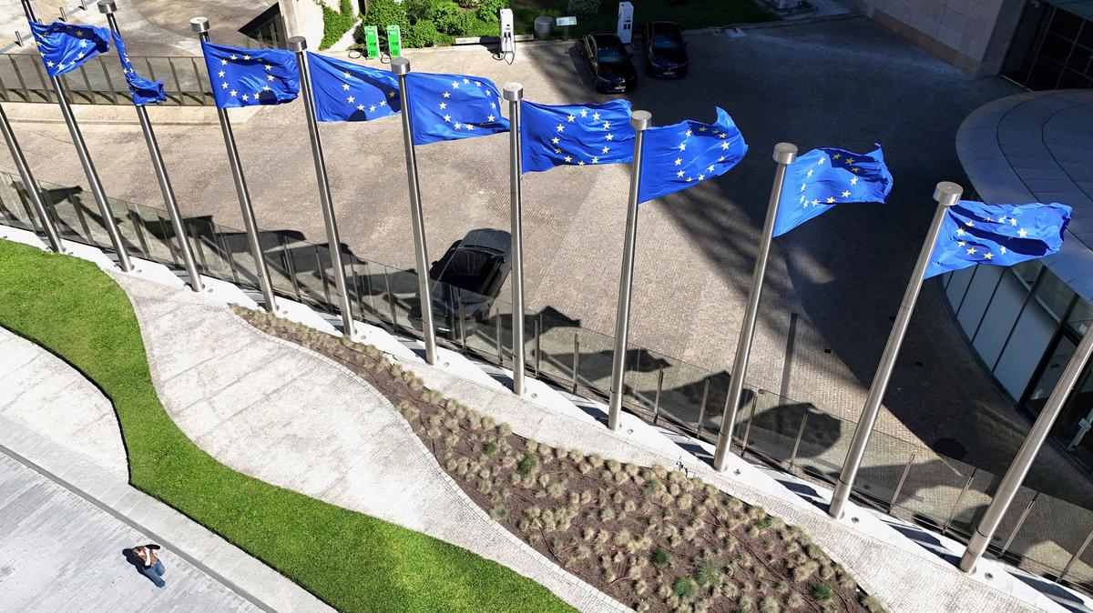 A drone view shows the European Union flags outside the European Commission headquarters, known as the Berlaymont building in Brussels, Belgium, April 29, 2026. REUTERS/Yves Herman
