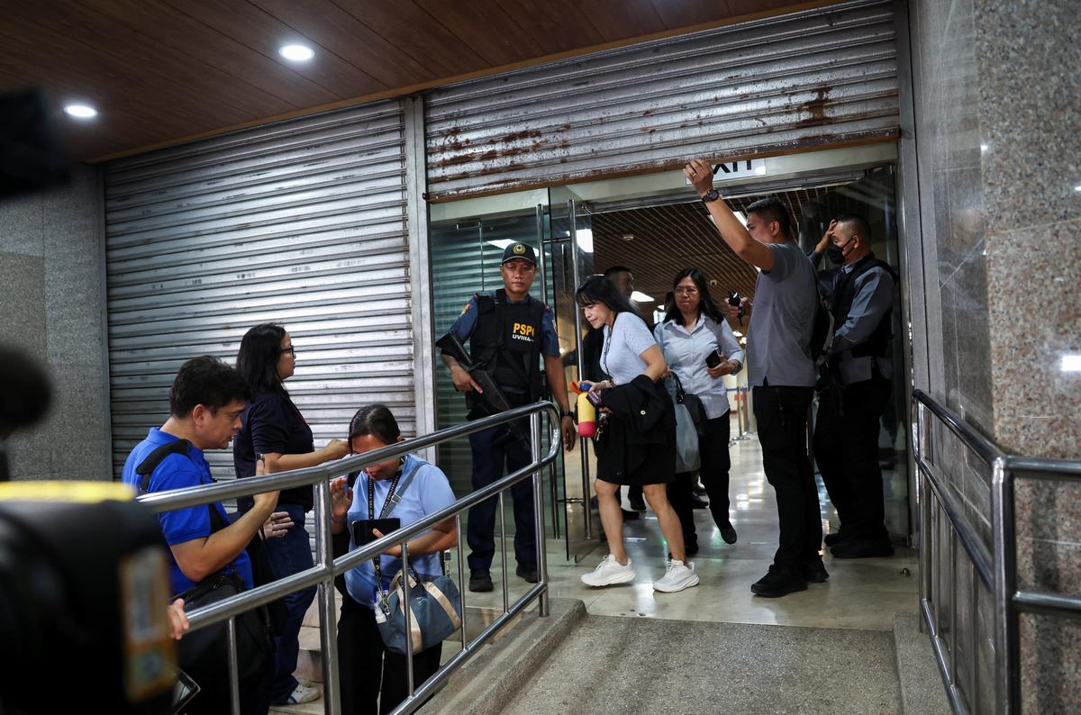 Senate security personnel and police officers work at the site, after gunshots were heard at the Philippine Senate, as chaos mounted in anticipation of an attempt to arrest a top senator wanted by the International Criminal Court, in Pasay City, Metro Manila, Philippines, May 13, 2026. REUTERS/Eloisa Lopez