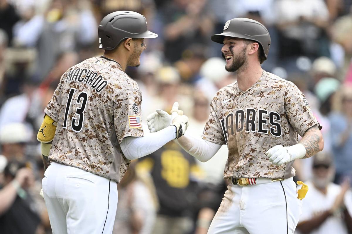  San Diego Padres center fielder Jackson Merrill (3), right, and third baseman Manny Machado (13)