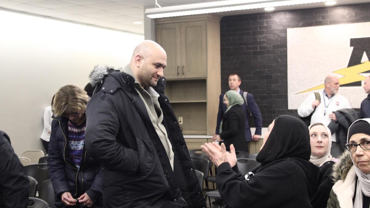 Waleed Atawneh, who publicly supports adding Arabic as a world language in School District 230 classrooms, speaks with another curriculum supporter after a district board meeting on Feb. 26, 2026. The board discussed the process for adding the curriculum for over an hour, but did not take any action. (Addison Wright/The Daily Southtown/Chicago Tribune/TNS)