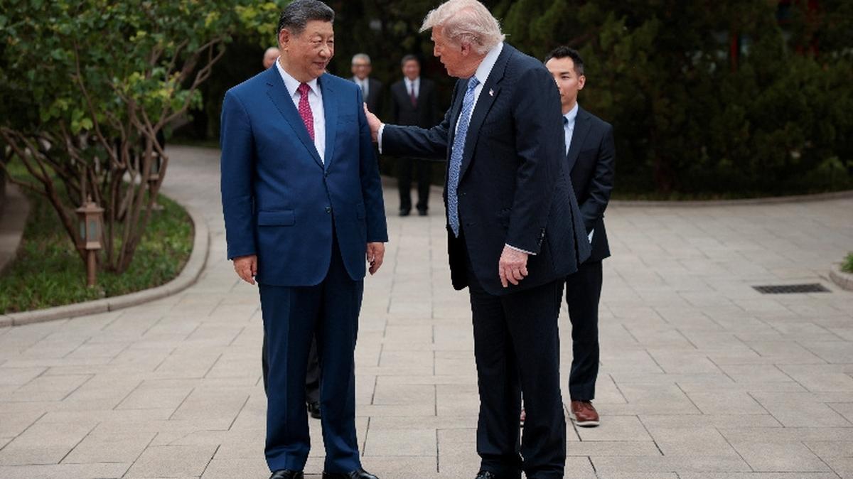 U.S. President Donald Trump speaks with Chinese President Xi Jinping while leaving after a visit to the Zhongnanhai Garden in Beijing, China, May 15, 2026. REUTERS/Evan Vucci/Pool
