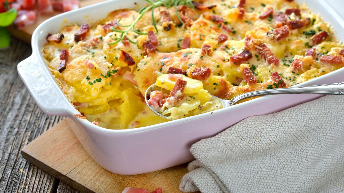 Hearty potato gratin with parmesan cheese, cream and delicious cured bacon from South Tyrol freshly served from the oven