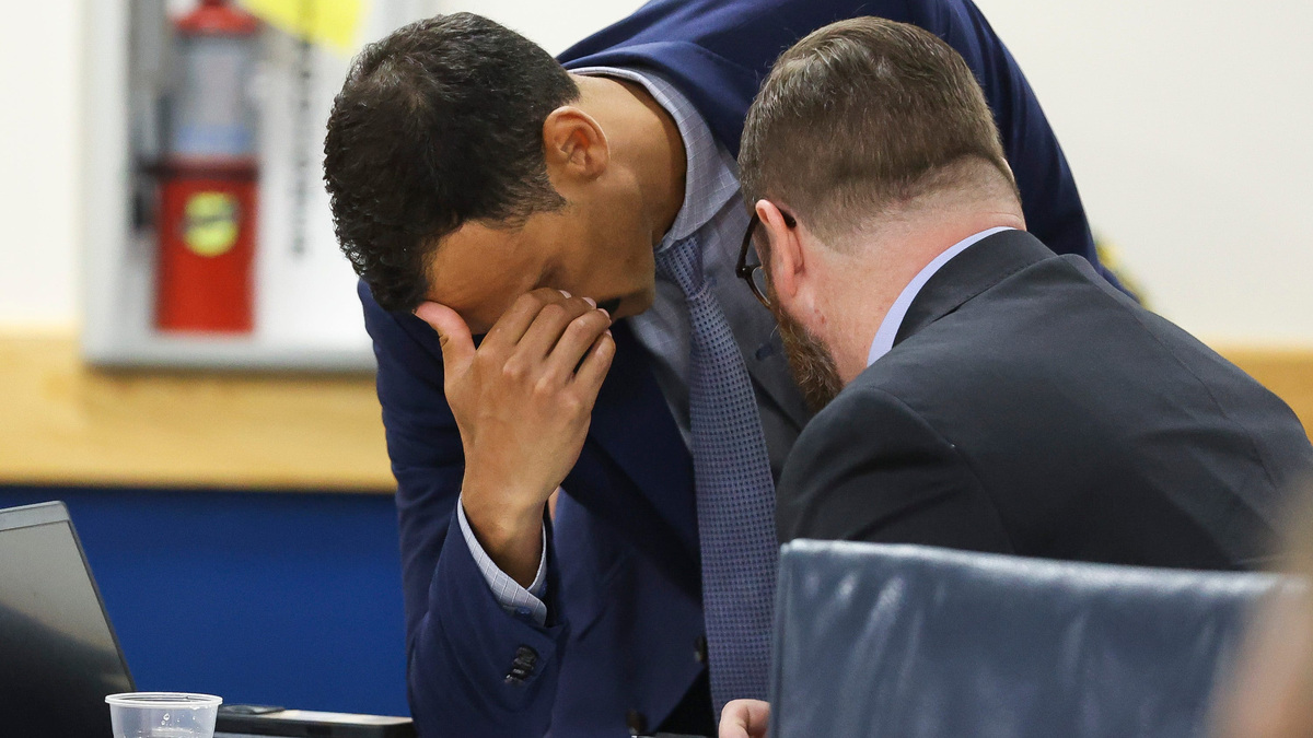 Attorney Martin Powell, left, speaks with his client Matt Theobald during Theobald's administrative hearing in Administrative Law Judge Jodi-Ann Livingstone's courtroom, April 2, 2026, at the Martin County Courthouse in Stuart. The hearing will determine the fate of Theobald's employment with the Martin County School District following his social media post last year about the death of conservative activist Charlie Kirk. Theobald was a teacher at Spectrum Academy in Stuart and president of the district's teachers union, the Martin County Education Association, when he allegedly posted that Kirk was a "racist, misogynistic, fear-mongering, xenophobic neo-Nazi."