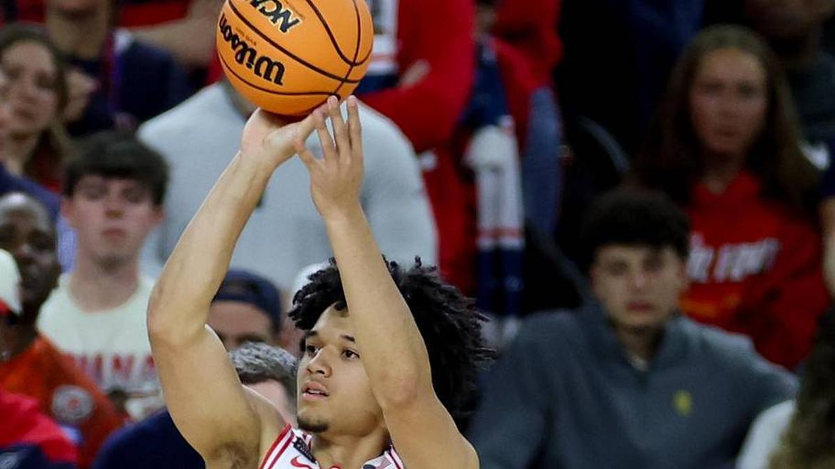  Apr 4, 2026; Indianapolis, IN, USA; Arizona Wildcats guard Brayden Burries (5) attempts a three-pointer against the Michigan Wolverines in the second half during a semifinal of the Final Four of the men's 2026 NCAA Tournament at Lucas Oil Stadium. Mandatory Credit: Trevor Ruszkowski-Imagn Images | Trevor Ruszkowski-Imagn Images 