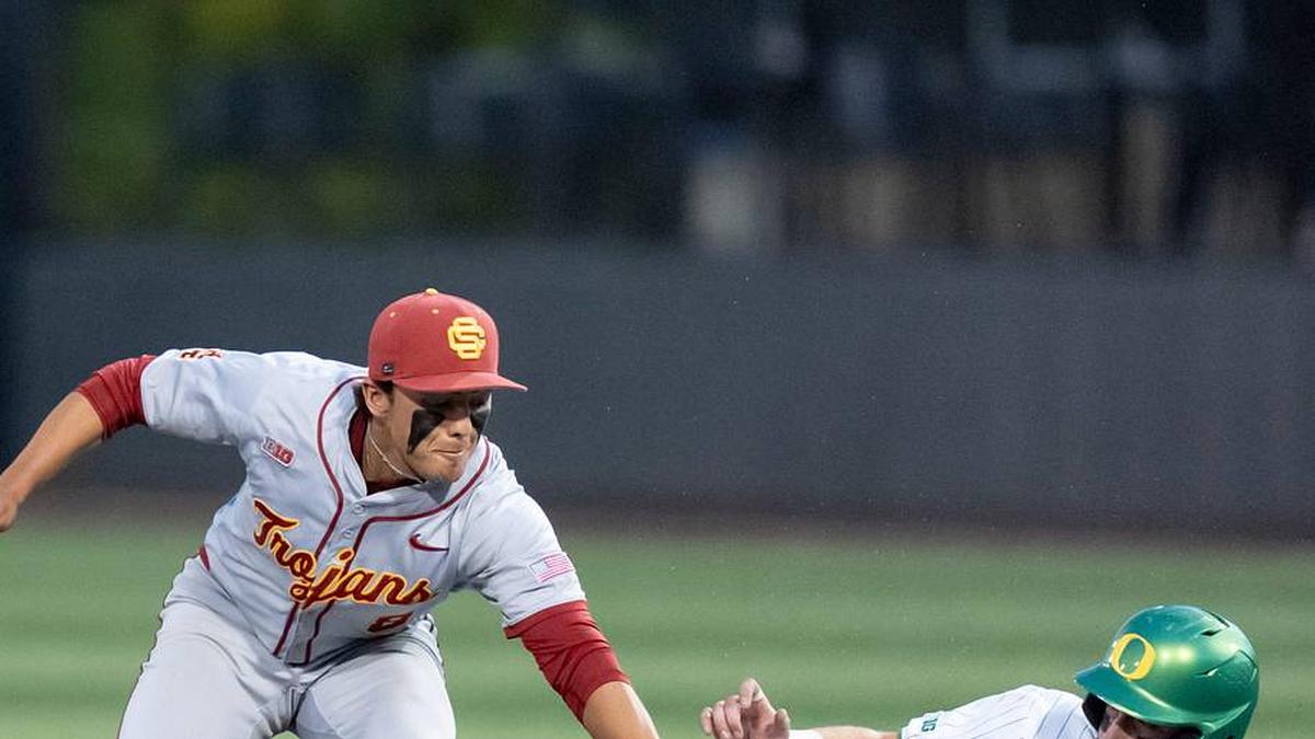 USC's Kevin Takeuchi, left, tags Oregon infielder Ryan Cooney as he slides to second as the Oregon Ducks host the USC Trojans on May 14, 2026, in Eugene, Oregon. | Ben Lonergan/The Register-Guard / USA TODAY NETWORK via Imagn Images 