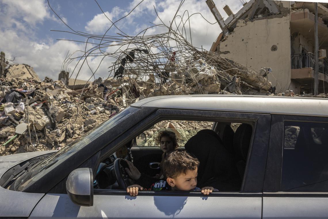 A family drives through the ruins of the southern Lebanese village of Mansouri, on Tuesday, April 21, 2026. The U.S. State Department will host a second round of ambassador-level talks between Israel and Lebanon, which are in a cease fire, on Thursday, the department said. (David Guttenfelder/The New York Times)