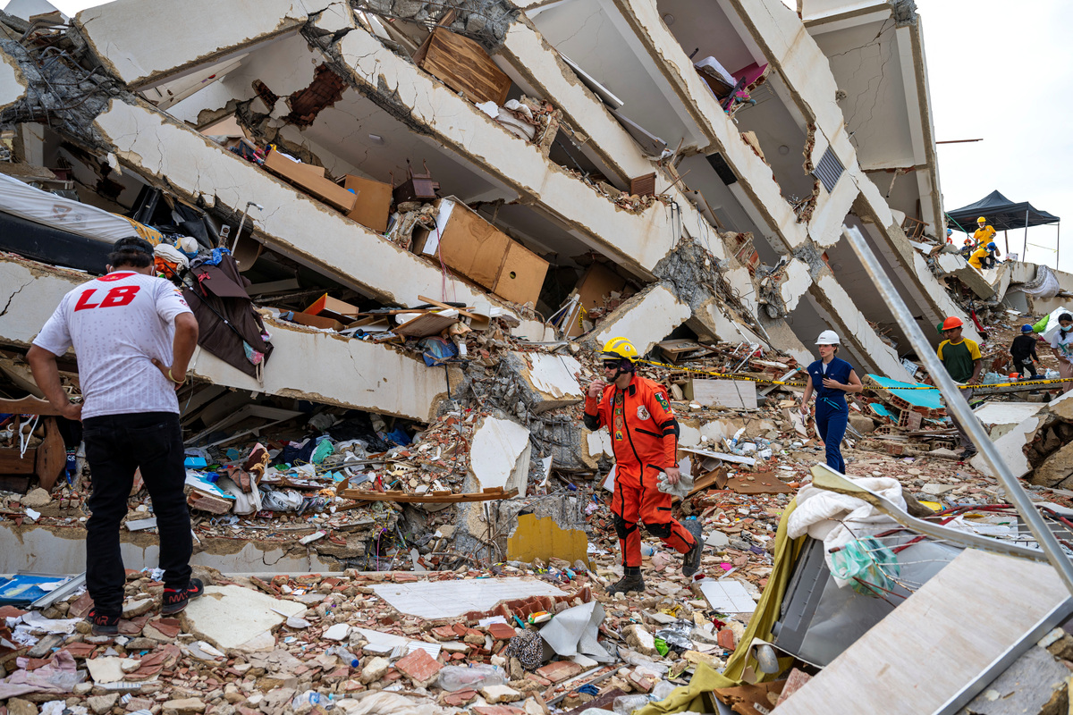 Volunteers and a Mexican rescuer help to find survivors in a collapsed building in Caraballeda, La Guaira state, Venezuela, on June 30, 2026, following the June 24 twin earthquakes.  MIGUEL MEDINA/Pool via REUTERS