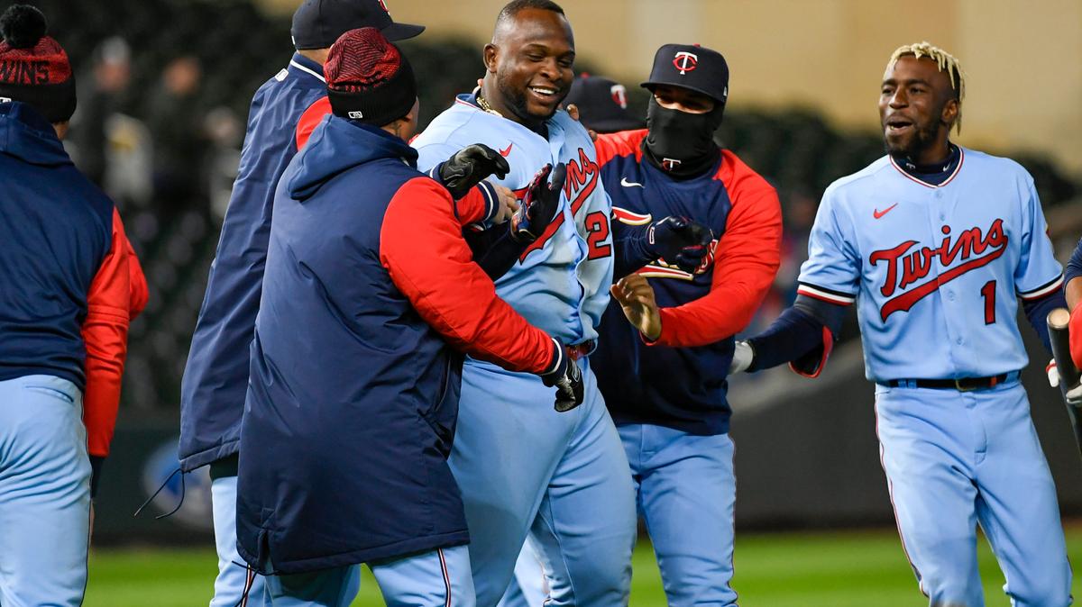Minnesota Twins’ Miguel Sano, third from right, celebrates with teammates after Sano hit a single during the ninth inning of a baseball game against the Detroit Tigers during a baseball game Tuesday, April 26, 2022, in Minneapolis. There was an error on the play, and the Twins scored two runs, winning 5-4. (AP Photo/Craig Lassig)