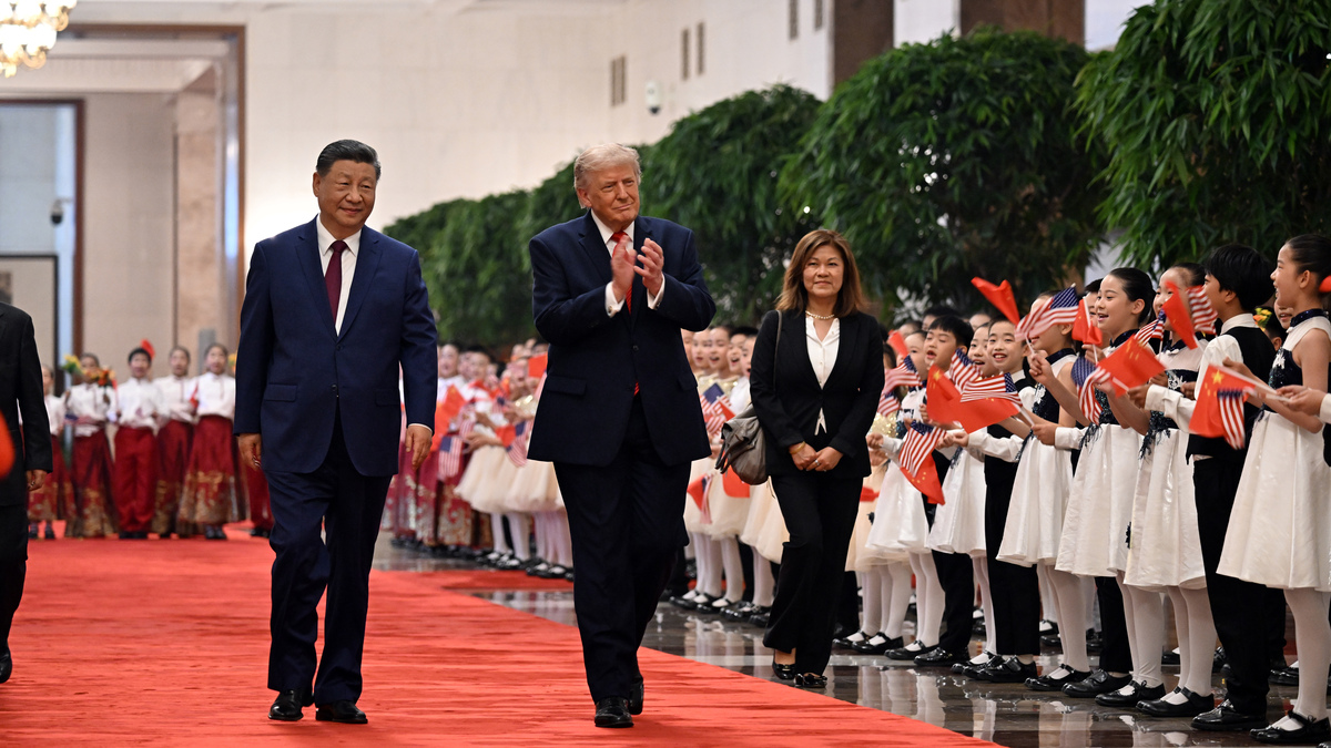 FILE -- From left, President Xi Jinping of China escorts President Donald Trump to a welcome ceremony at the Great Hall of the People in Brijing on May 14, 2026. China on July 17, 2026, rejected Trump's claim that it had meddled in American elections as baseless. But its response was relatively restrained. (Kenny Holston/The New York Times)