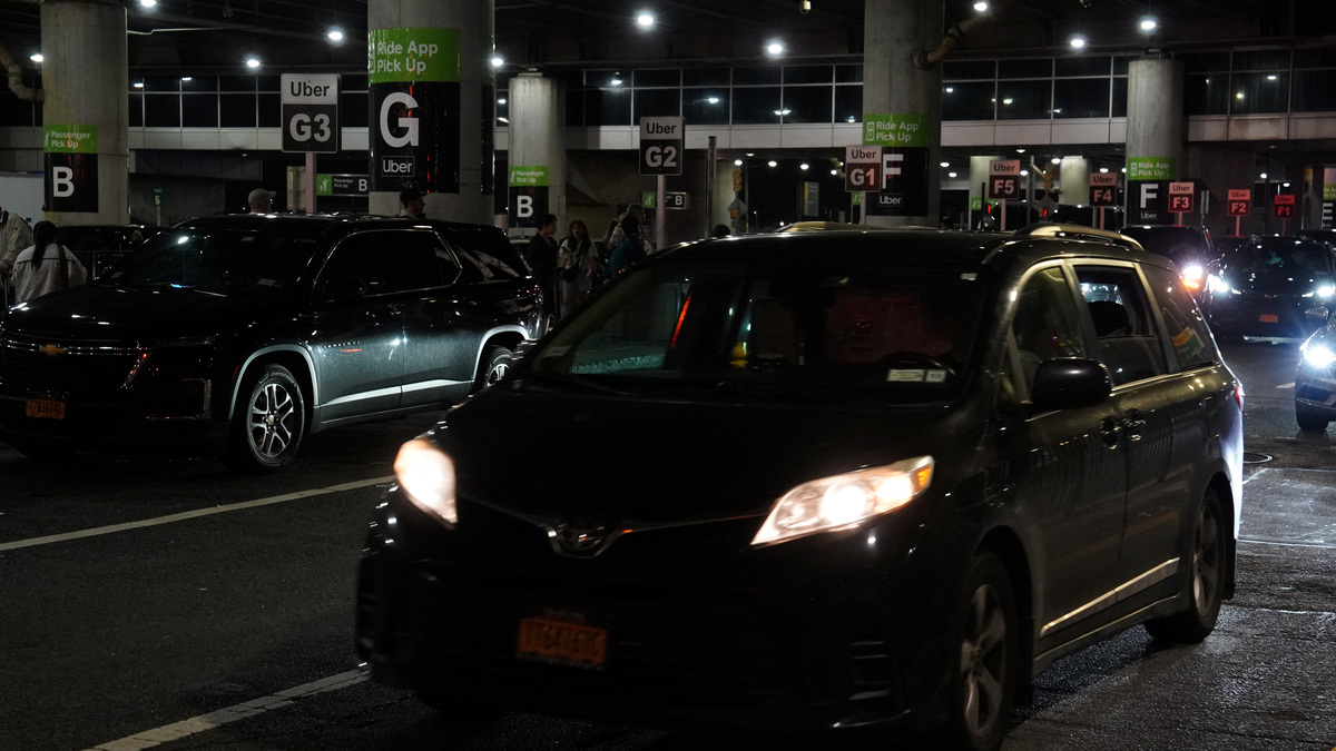 Ride-sharing vehicles arrive at an Uber passenger pick-up area at Terminal 8 at John F. Kennedy International Airport, in New York, U.S., June 8, 2025. REUTERS/Bing Guan