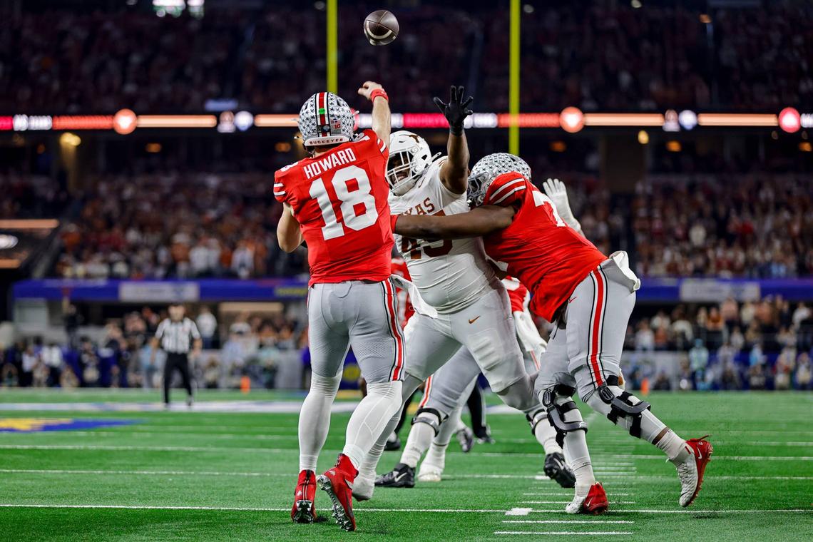  ARLINGTON, TX - JANUARY 10: Quarterback Will Howard #18 of the Ohio State Buckeyes passes the football over Defensive Lineman Vernon Broughton #45 of the Texas Longhorns during the Ohio State Buckeyes versus Texas Longhorns College Football Playoff Semifinal at the Cotton Bowl Classic on January 10, 2025, at AT&T Stadium in Arlington, TX. (Photo by Matthew Pearce/Icon Sportswire via Getty Images) 