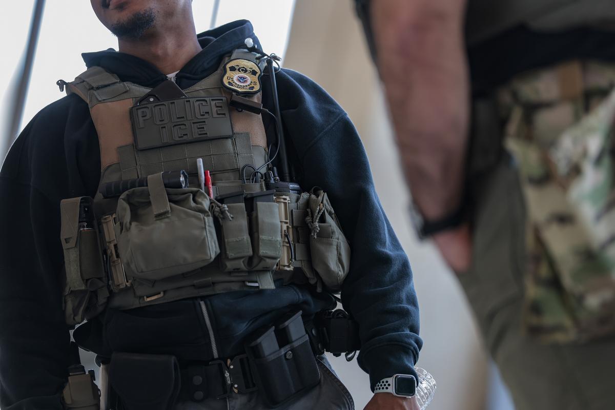 Immigration and Customs Enforcement (ICE) agents patrol Dulles International Airport on March 24, 2026 in Dulles, Virginia. 