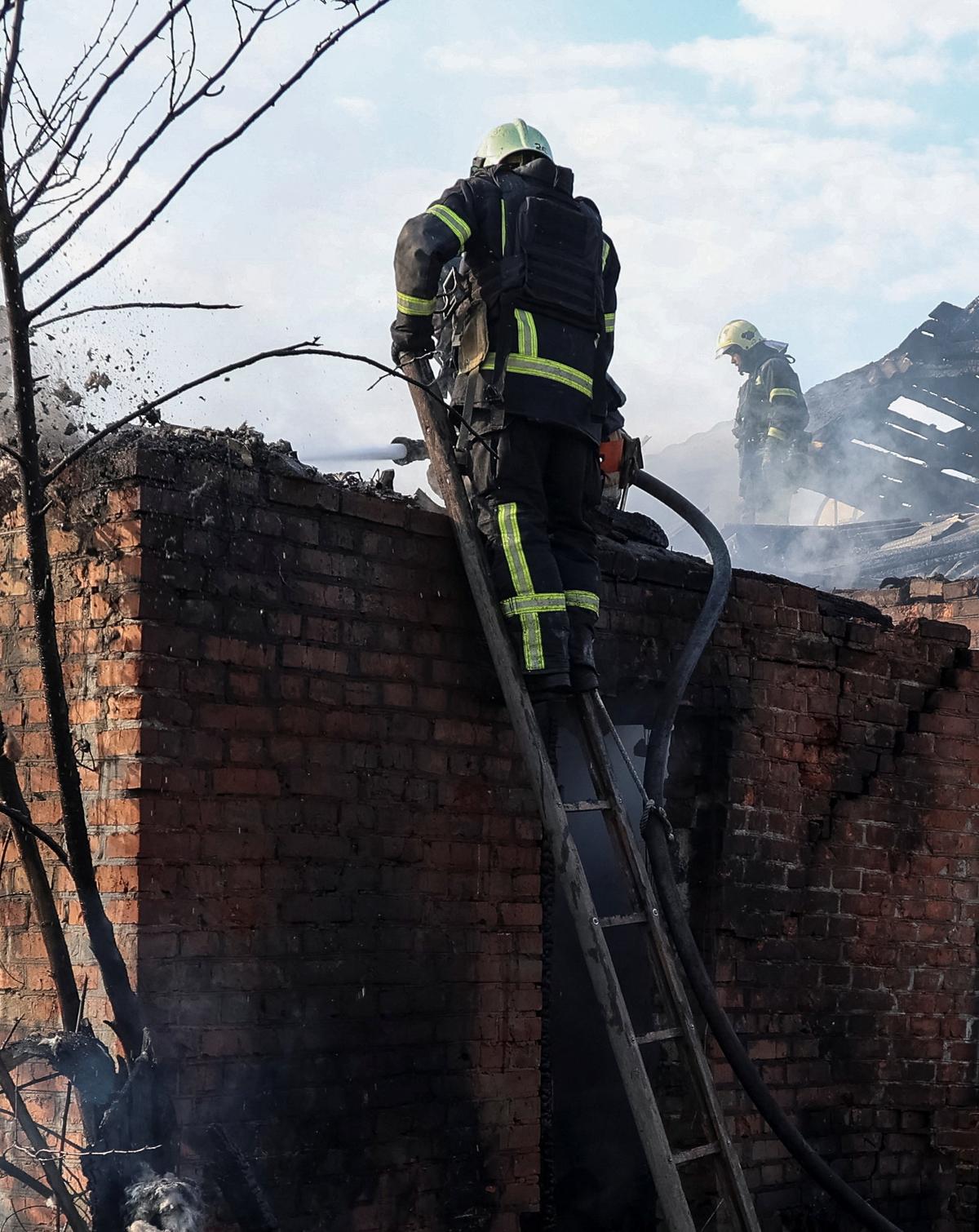 Rescuers work at the site of the private house hit by a Russian drone strike, amid Russia's attack on Ukraine, in Kharkiv, Ukraine May 6, 2026.  REUTERS/Vyacheslav Madiyevskyy