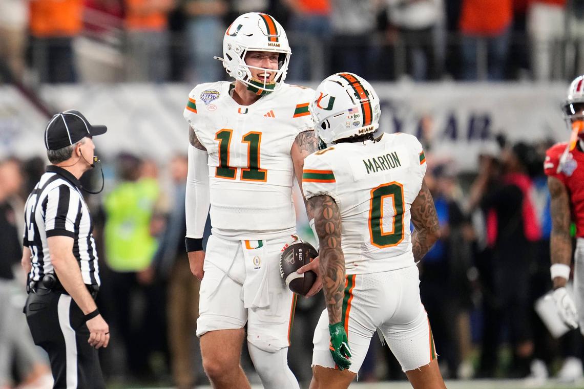  Miami Hurricanes quarterback Carson Beck (11) celebrates with wide receiver Keelan Marion (0) the Cotton Bowl at AT&T Stadium in Arlington, Texas for the College Football Playoff quarterfinal game against the Ohio State Buckeyes on Dec. 31, 2025. Ohio State lost 24-14. 