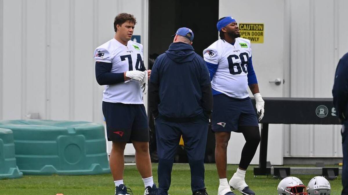  May 9, 2026; Foxborough, MA, USA; New England Patriots rookie tackle Caleb Lomu (74) talks to a member of the coaching staff at the New England Patriots rookie camp at Gillette Stadium. Mandatory Credit: Eric Canha-Imagn Images | Eric Canha-Imagn Images 