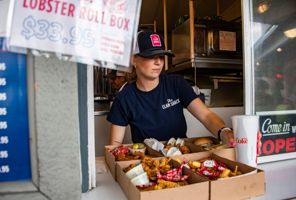  A server puts together an order of fried food at The Clam shack in Kennebunkport, Maine on July 22, 2022. 