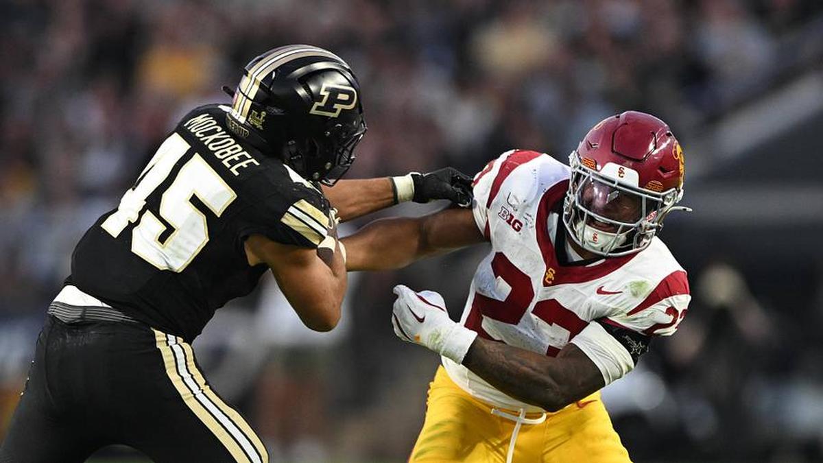  Sep 13, 2025; West Lafayette, Indiana, USA; Purdue Boilermakers running back Devin Mockobee (45) fights to get past USC Trojans linebacker Desman Stephens II (23) during the second quarter at Ross-Ade Stadium. Mandatory Credit: Marc Lebryk-Imagn Images | Marc Lebryk-Imagn Images 