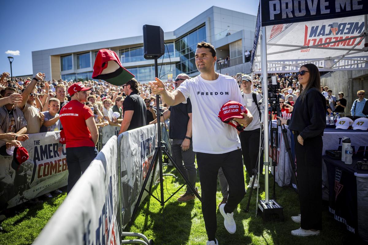  Charlie Kirk hands out hats before speaking at Utah Valley University in Orem, Utah, on September 10, 2025. 